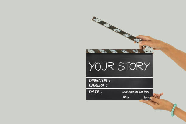your story.text title on film slate Hand holding a film clapboard slate or movie slate. cinematic music photos stock pictures, royalty-free photos & images
