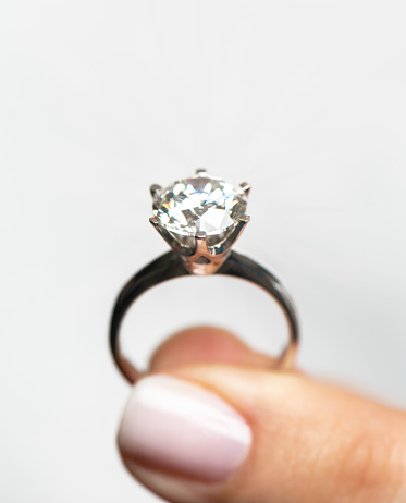 Woman showing a diamond ring.