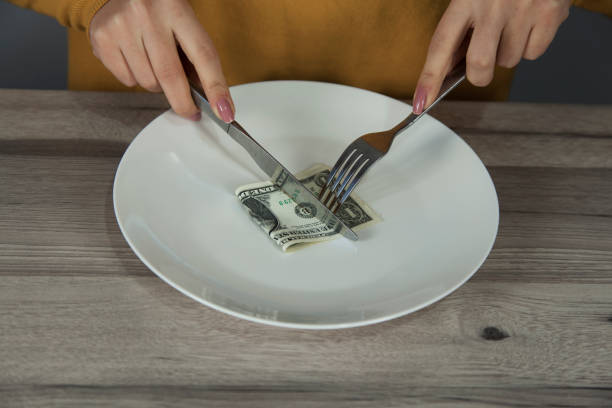 istock woman  hand  dollar on  plate 1200766028