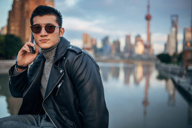 istock Fashionable young man is talking on phone 1200766067