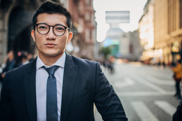 istock Handsome businessman is walking on the street 1200766178