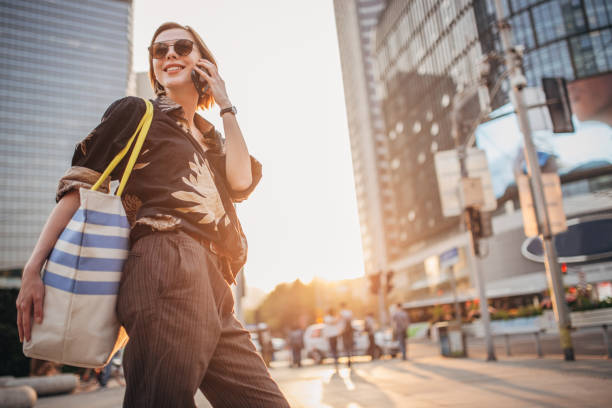 istock Happy young woman is talking on phone 1200767554