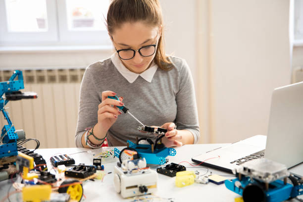 istock Girl building robot 1200767617
