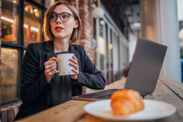 istock Elegant young woman is drinking coffee 1200767706