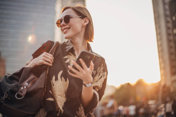 istock Stylish young woman is text messaging 1200768034