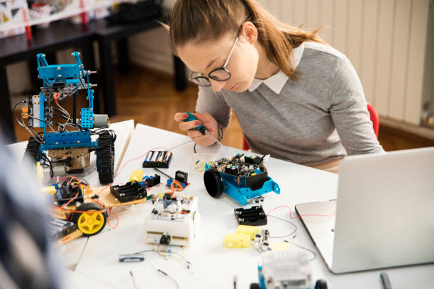 istock Girl building robot 1200768259