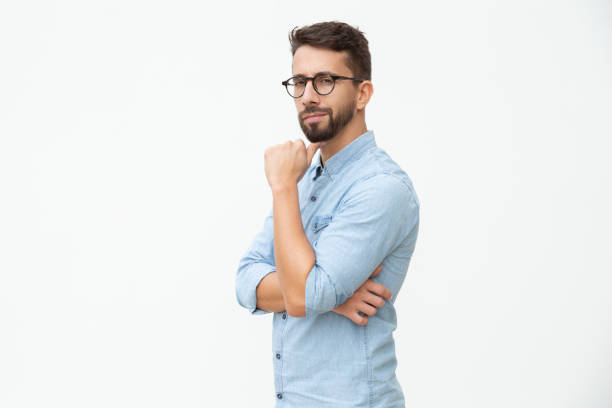 istock Confident man with hand on chin looking at camera 1200768349