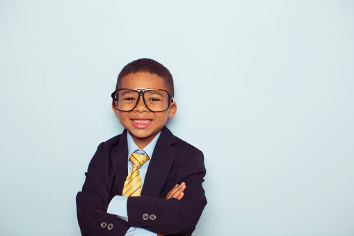 An adorable male child in a formal suit outfit posing