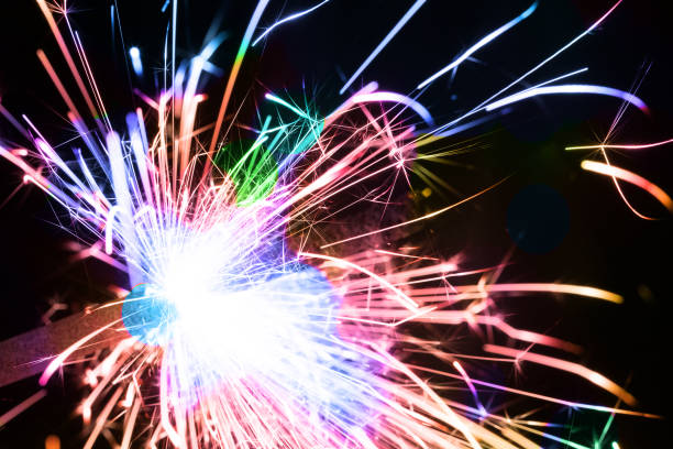 istock Multicolored sparklers or bengal light burning over black 1200769434