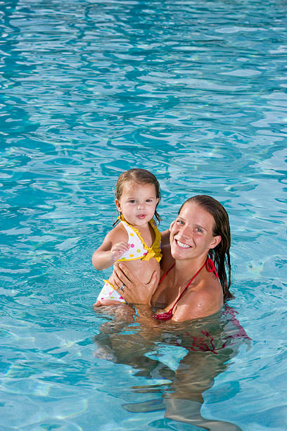 istock Mother and young daughter enjoying swimming pool 120077026
