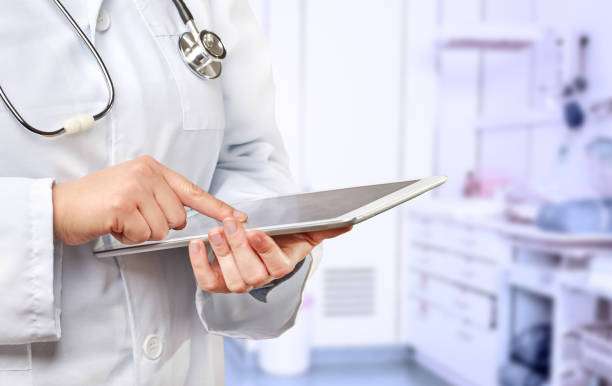 Female doctor touching a tablet