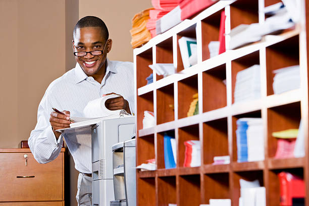 Smiling African American businessman reading through paper