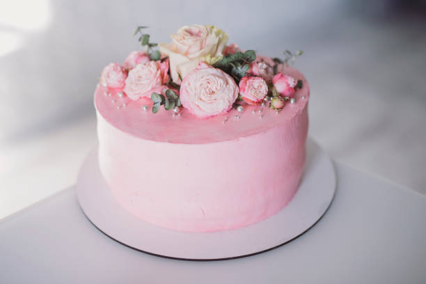 istock Beautiful delicious pink cake with roses 1200772231