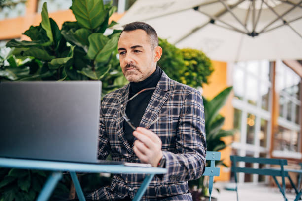 istock Mature elegant businessman is working on laptop 1200773445