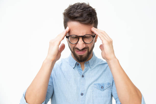 stressed man suffering from headache - isolated businessman sadness business person imagens e fotografias de stock