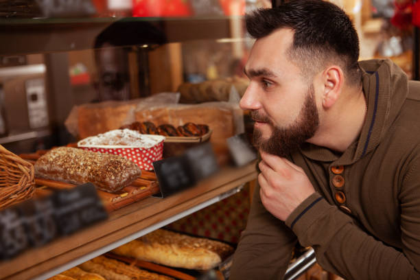 istock Bearded man shopping at the bakery 1200774078