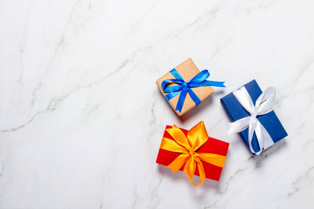istock Gift boxes on a marble background. Holiday concept, presents. Flat lay, top view 1200774086
