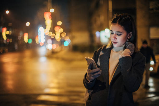 istock Young woman is text messaging on the street 1200774338