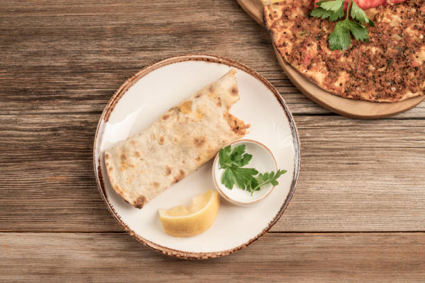 istock bitten turkish pizza on wooden table 1200774962
