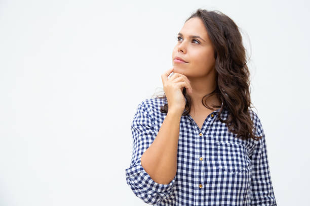 istock Pensive young woman looking aside 1200775106