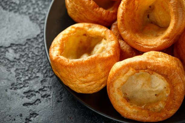 istock Traditional English Yorkshire pudding side dish on black plate and background 1200777312