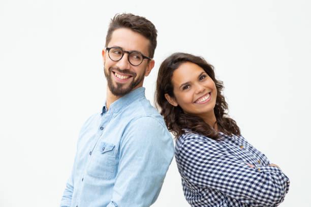 Content man and woman standing back to back