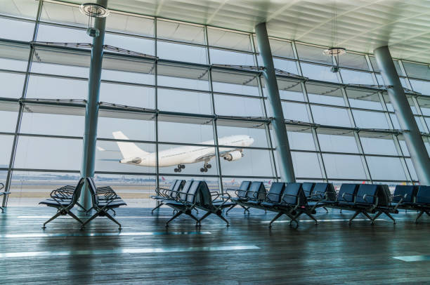 Empty airport departure lounge and airplane take off