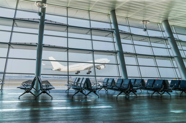 empty airport departure lounge and airplane take off - airport interior imagens e fotografias de stock
