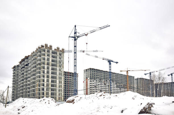 istock Construction site, new building and crane, gray sky 1200778778
