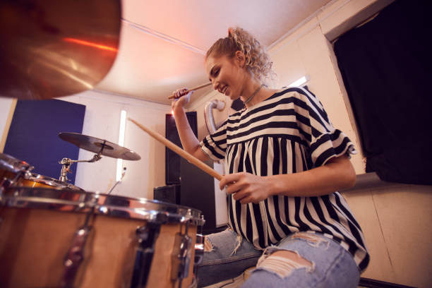 istock Cheerful Young Woman Plying Drums 1200778923