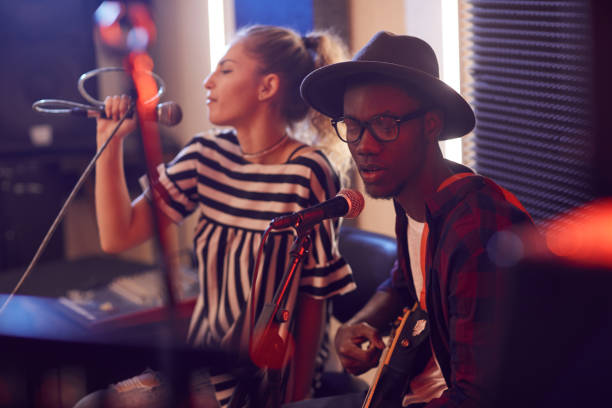 Young African Man Singing with Band in Studio
