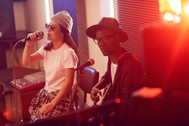istock Young African Man Singing with Music Band in Studio 1200778955