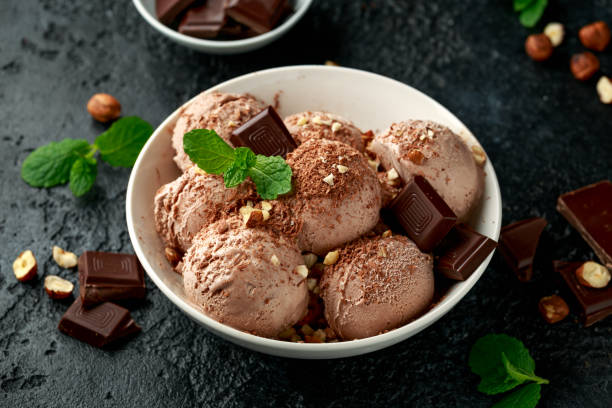 istock Chocolate Ice Cream with dark chocolate bars and hazelnuts in a white bowl 1200778997