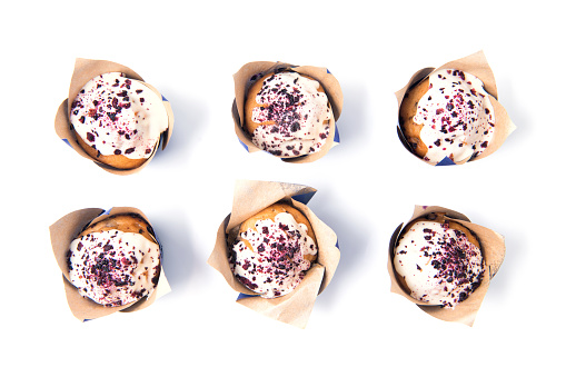 Homemade tasty blueberry muffins with white chocolate isolated on white background, food pattern, top view