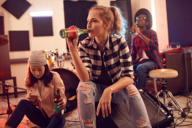 istock Contemporary Young People Drinking Beer in Music Studio 1200779764