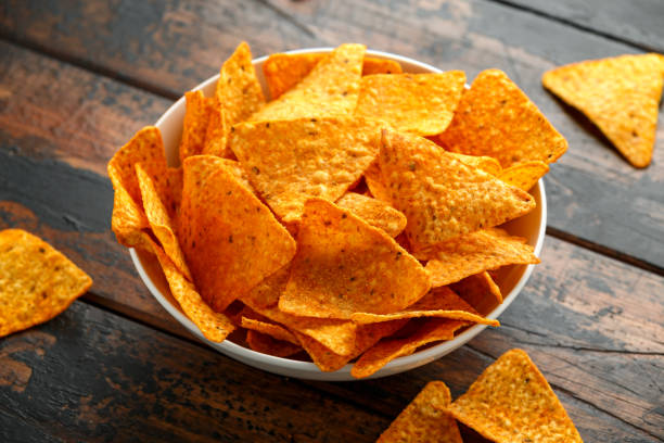 istock Mexican corn, tortilla cheese chips in a white cup on wooden table 1200779972