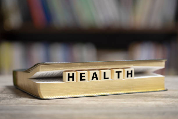 istock Book on desk with Health word 1200780211