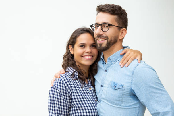 istock Happy young couple standing and embracing 1200780529