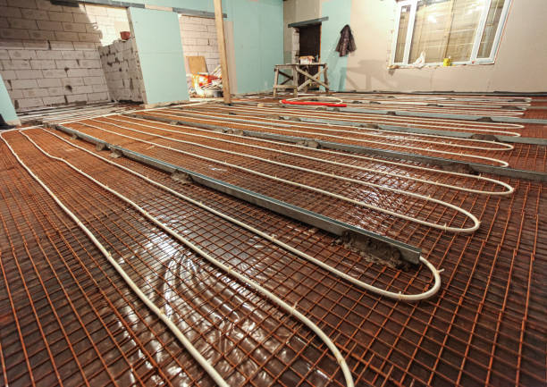 istock Pipefitter installing system of heating or underfloor heating installation. Water floor heating system interior. Plumbing pipes in apartment during under construction, remodeling, renovation, extension, restoration, reconstruction, upgrade 1200780731