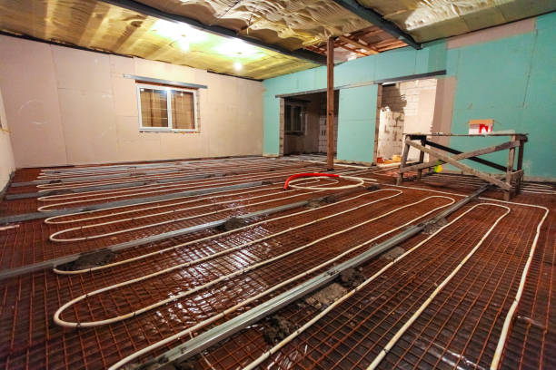 istock Pipefitter installing system of heating or underfloor heating installation. Water floor heating system interior. Plumbing pipes in apartment during under construction, remodeling, renovation, extension, restoration, reconstruction, upgrade 1200781243