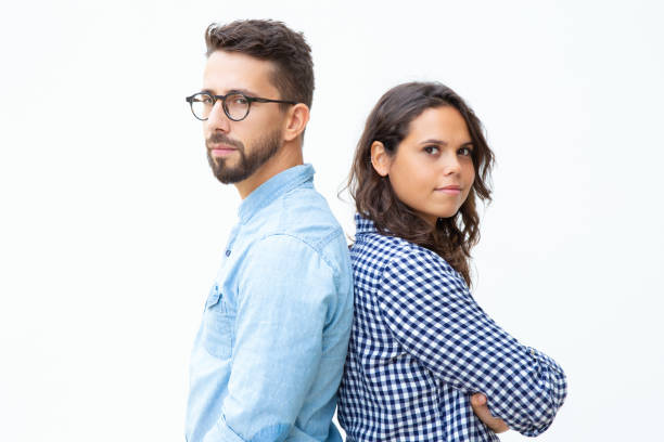 istock Confident man and woman standing back to back 1200781374