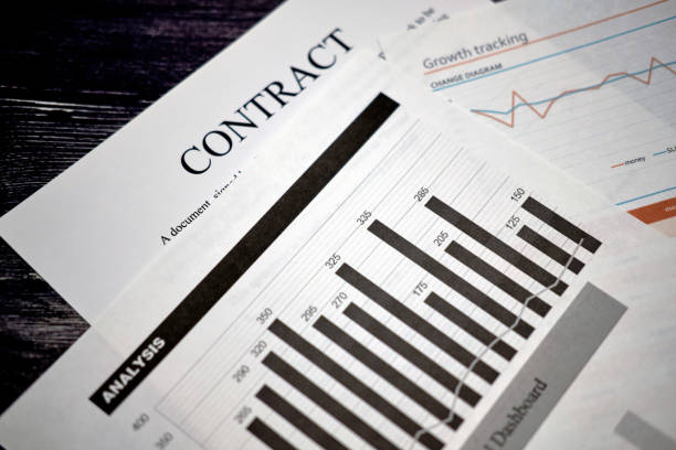 istock Contract and charts with analysis of financial indicators 1200781420