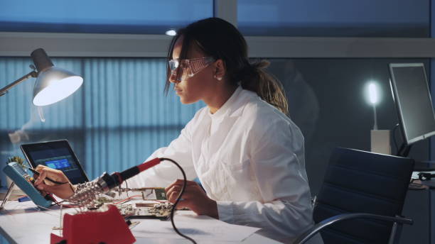 istock Side view of african american electronics specialist working with multimeter tester and other electronic devices in laboratory 1200783006