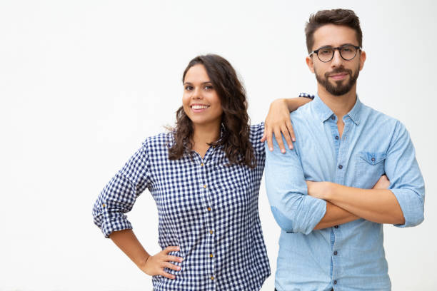 istock Couple standing together and smiling at camera 1200783031