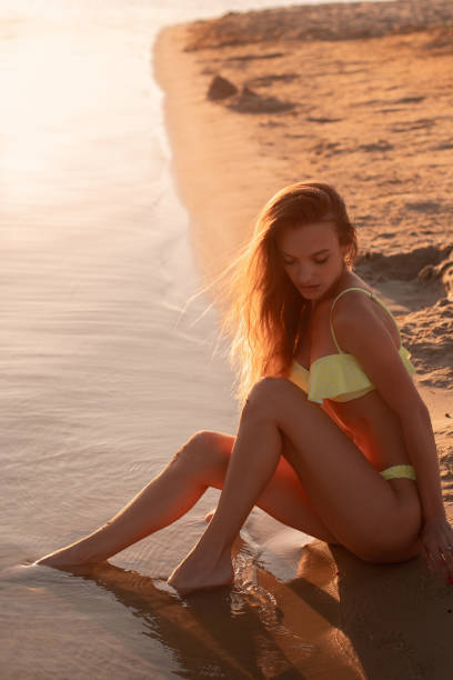 istock young girl at sunset at the beach 1200783077