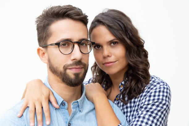 istock Young couple embracing and looking at camera 1200784504
