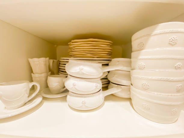 istock Stacks of White Dishes in Painted White Kitchen Cabinet 1200785864