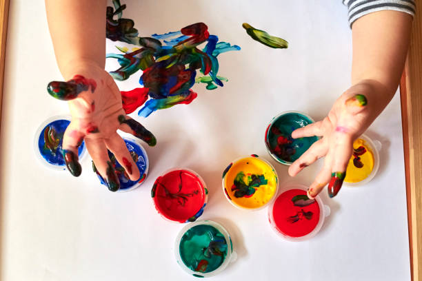 istock The child shows dirty hands after drawing with finger paints 1200786872