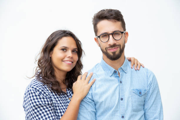 istock Cheerful young couple smiling at camera 1200787397
