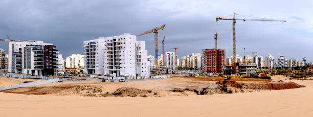 Building yard of Housing construction of houses in a new area of the city Holon in Israel City construction among desert dunes. Building yard of Housing construction of houses in a new area of the city Holon in Israel borough district type photos stock pictures, royalty-free photos & images